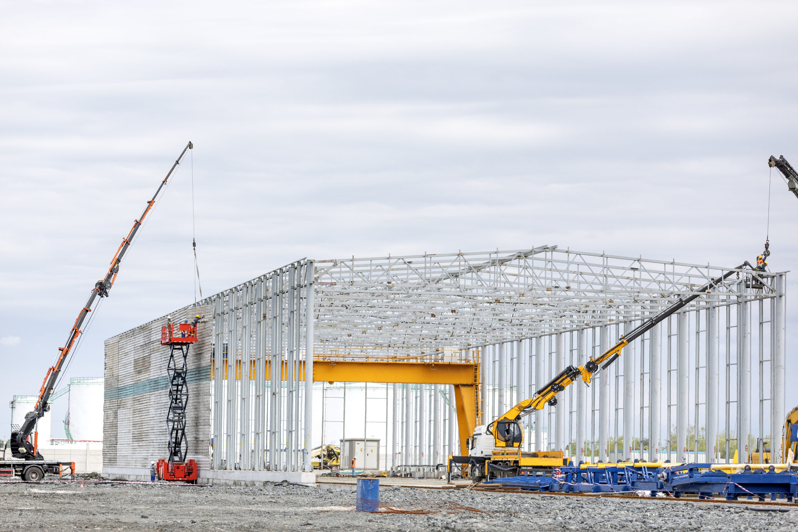Typical new steel structure building of factory. A steel building is a metal structure fabricated with steel for the internal support and for exterior cladding, as opposed to steel framed buildings.